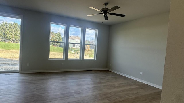 spare room with ceiling fan and dark wood-type flooring