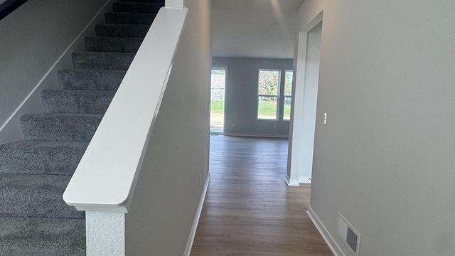 stairs featuring wood-type flooring