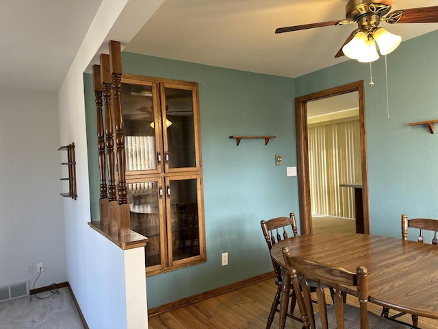 dining space featuring a wealth of natural light, hardwood / wood-style flooring, and ceiling fan