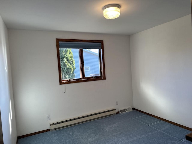 carpeted spare room featuring baseboard heating