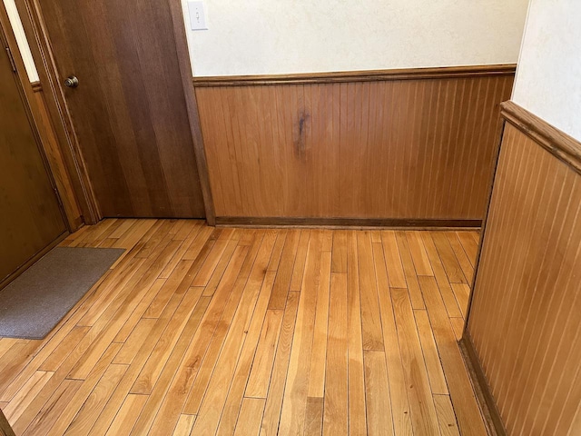 room details featuring hardwood / wood-style floors and wood walls