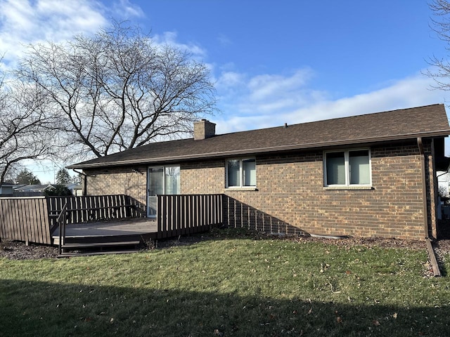 rear view of property featuring a wooden deck and a yard