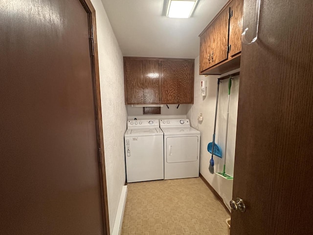 washroom with washer and clothes dryer and cabinets