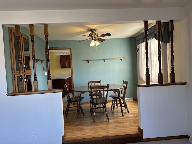 dining area featuring ceiling fan and wood-type flooring