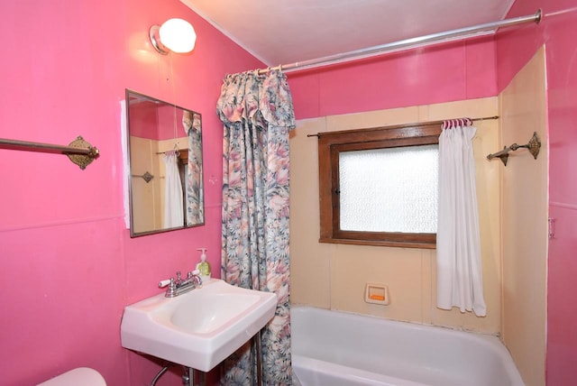 full bathroom with sink, shower / bathtub combination with curtain, and toilet