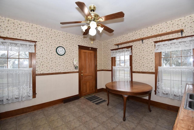 dining room featuring ceiling fan and a wealth of natural light