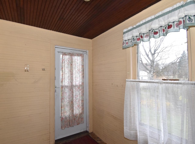 entryway with wooden walls and wood ceiling