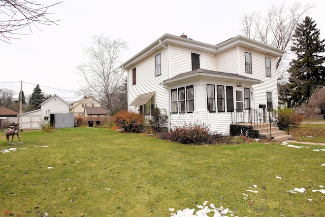 exterior space with a lawn and a sunroom