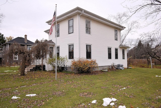 view of side of home with a lawn