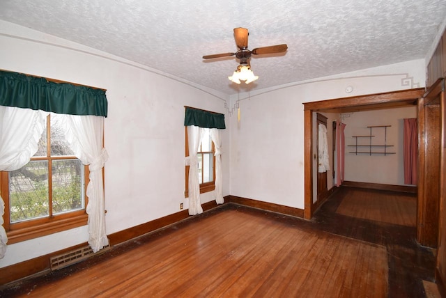 unfurnished room with vaulted ceiling, ceiling fan, a textured ceiling, and hardwood / wood-style flooring