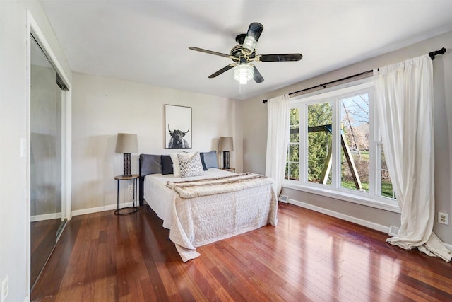 bedroom with ceiling fan, a closet, and dark hardwood / wood-style floors