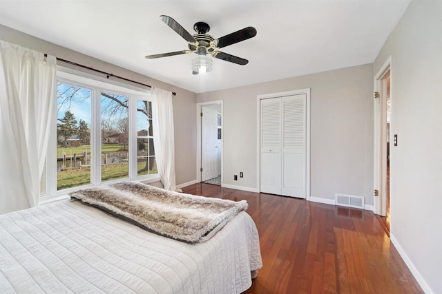 bedroom with ceiling fan and dark hardwood / wood-style flooring