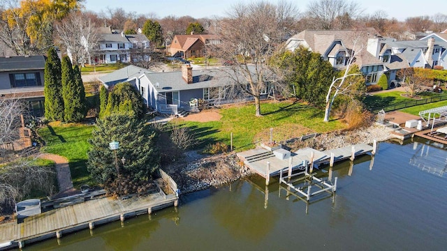 dock area featuring a lawn and a water view