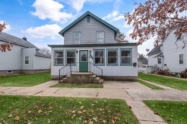 bungalow-style home featuring a front yard