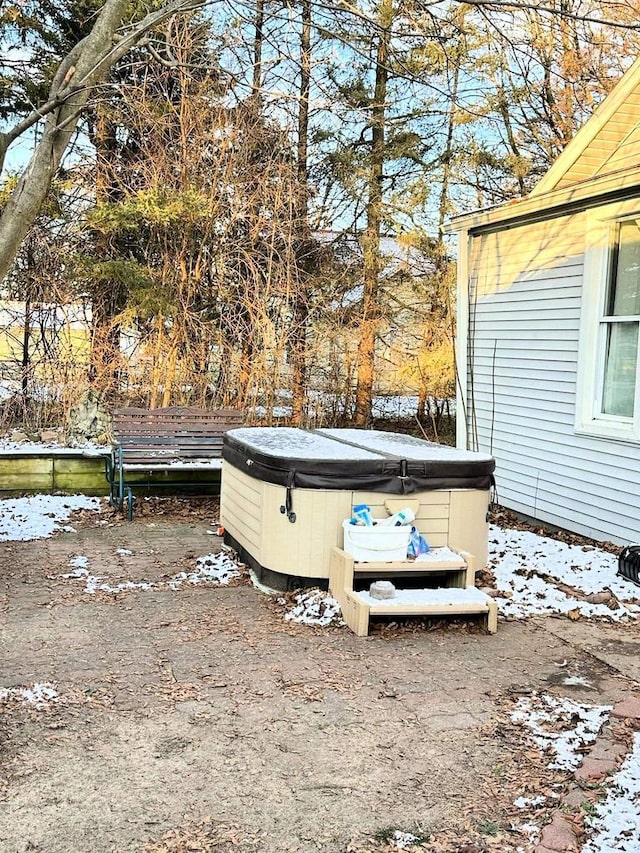 yard covered in snow with a hot tub