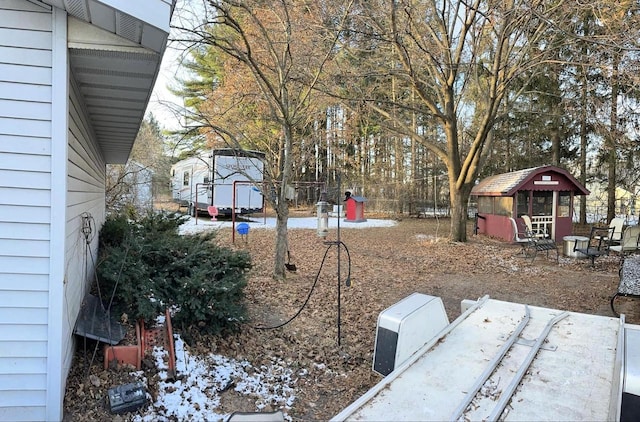 snowy yard with an outdoor structure