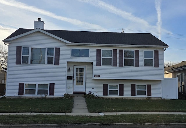 bi-level home with a front lawn