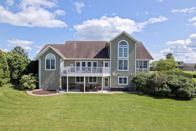 back of house featuring central AC unit, a deck, a yard, and a patio