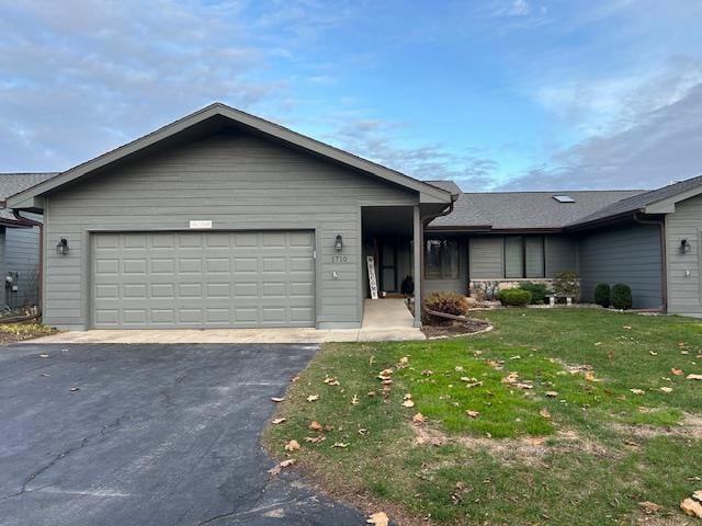 single story home with a front yard and a garage