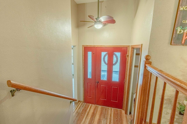 foyer entrance with hardwood / wood-style flooring and ceiling fan