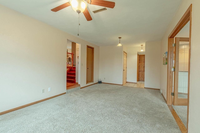 carpeted spare room with ceiling fan