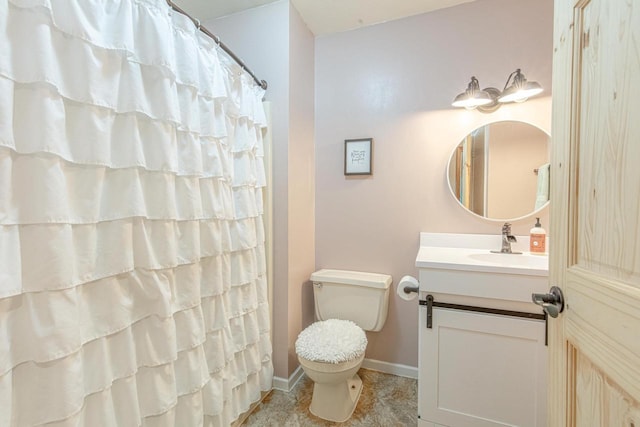 bathroom with walk in shower, vanity, and toilet