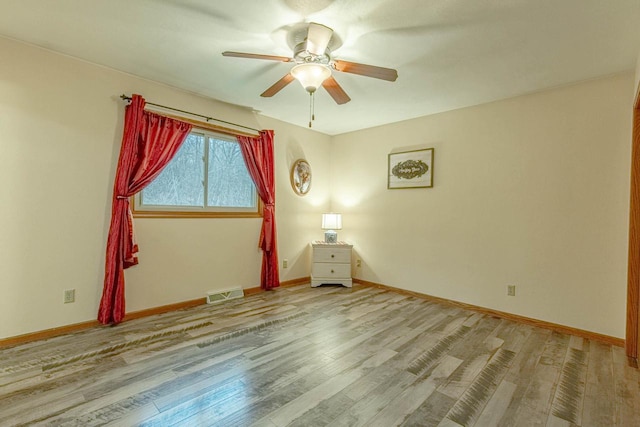 unfurnished room featuring ceiling fan and light hardwood / wood-style flooring