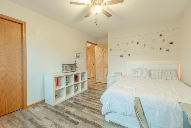 bedroom featuring hardwood / wood-style flooring and ceiling fan