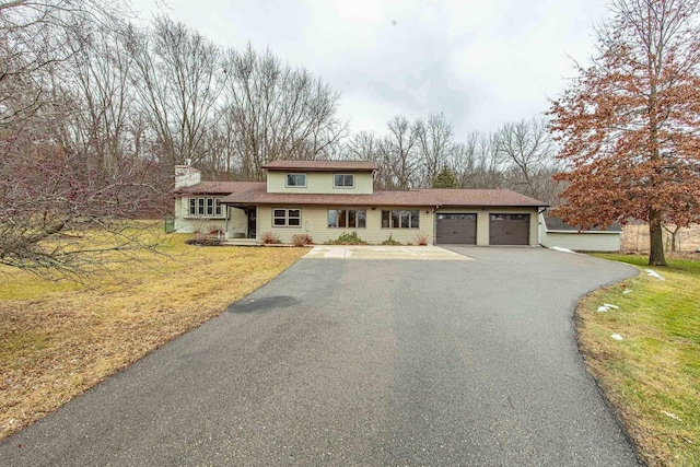 view of front of house with a front yard and a garage