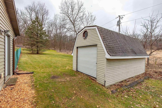 view of outdoor structure featuring a lawn and a garage