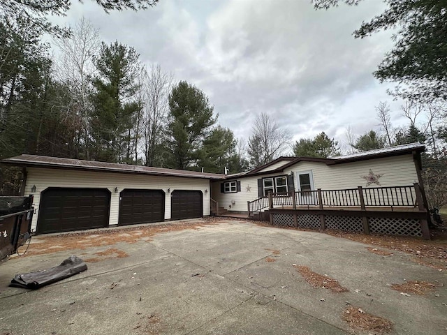 view of front of property with a garage and a wooden deck