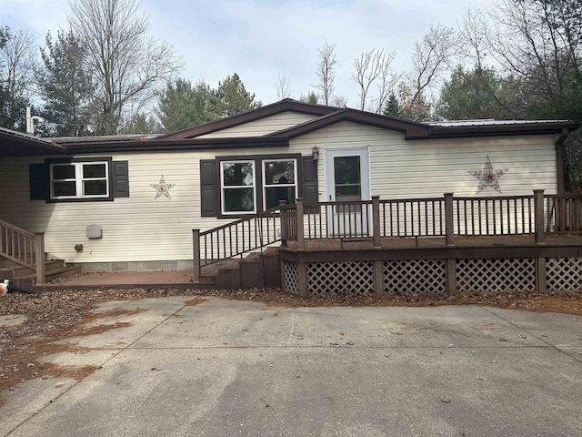 rear view of house with a patio and a wooden deck