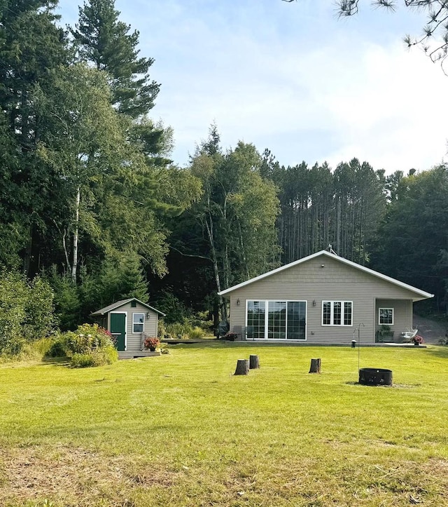 exterior space featuring a lawn and a shed