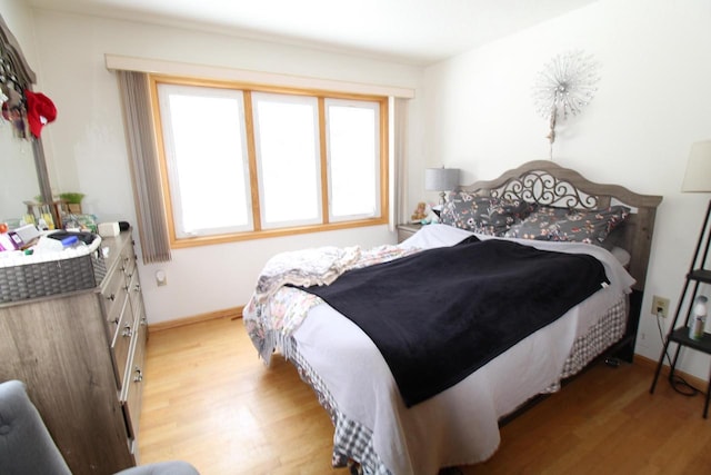 bedroom featuring multiple windows and light wood-type flooring