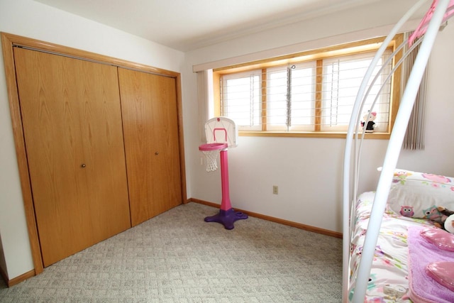 bedroom with light carpet and a closet