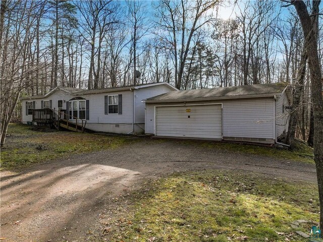 view of front of house with a deck and a garage