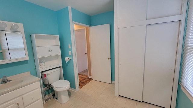 bathroom featuring tile patterned floors, vanity, and toilet