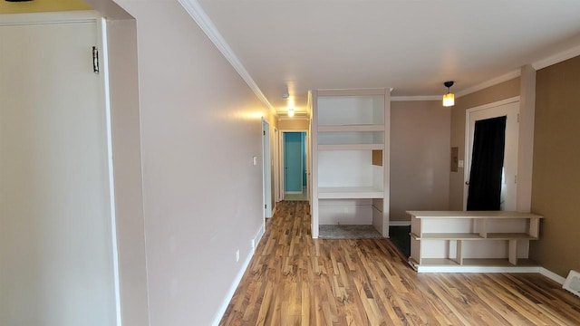 hallway featuring light wood-type flooring and ornamental molding