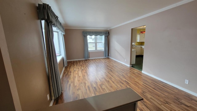 unfurnished room featuring hardwood / wood-style flooring and crown molding