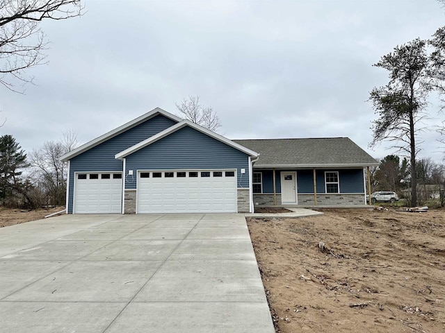 view of front of house with covered porch and a garage