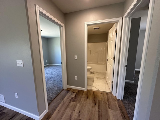 hallway featuring wood-type flooring