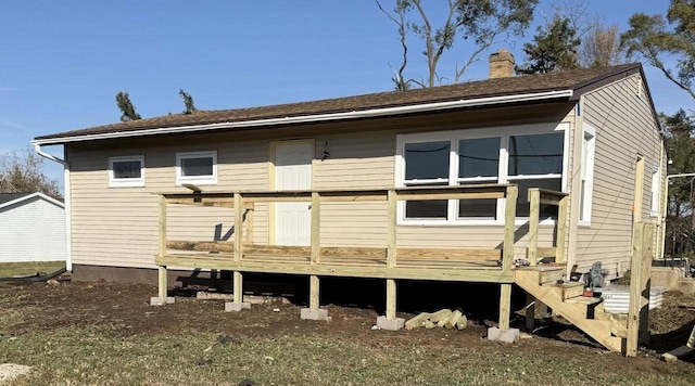 back of house featuring a wooden deck