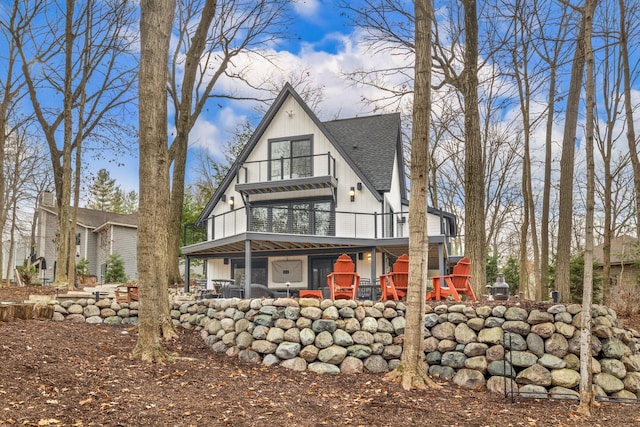 rear view of property featuring a balcony