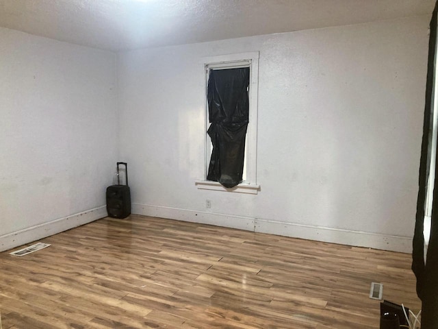 spare room featuring light hardwood / wood-style flooring