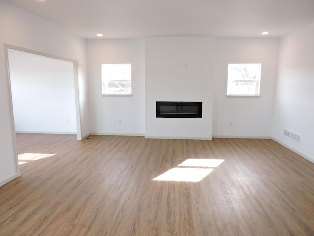 unfurnished living room featuring light wood-type flooring