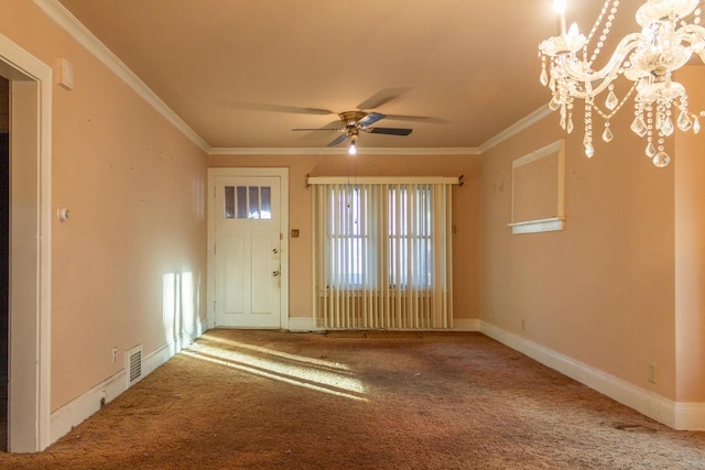 spare room with ceiling fan with notable chandelier, carpet floors, and crown molding