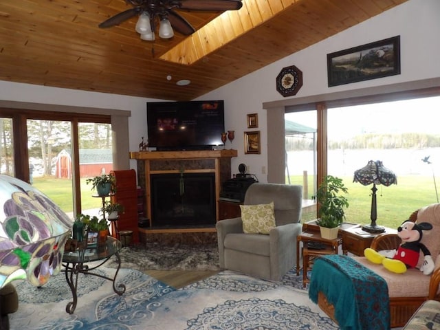 living room with hardwood / wood-style floors, ceiling fan, lofted ceiling, and a healthy amount of sunlight