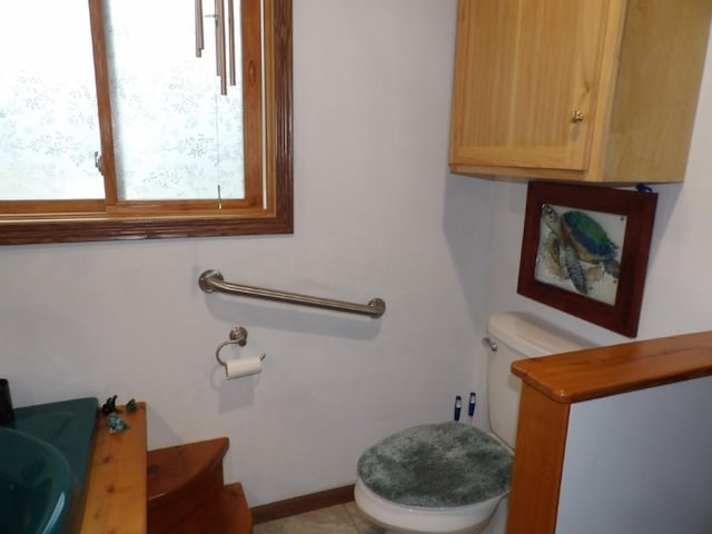 bathroom with tile patterned flooring, toilet, and sink