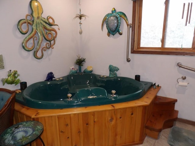 bathroom with tile patterned floors and a tub