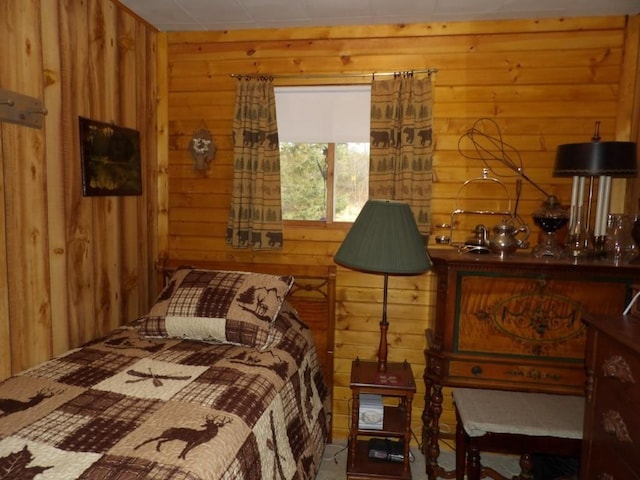 bedroom featuring wood walls